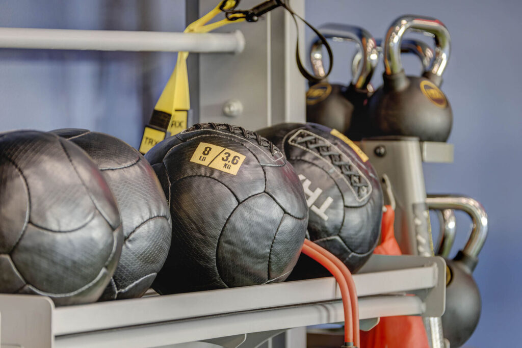 The indoor gym featuring wall balls and kettlebells for weight lifting exercises.