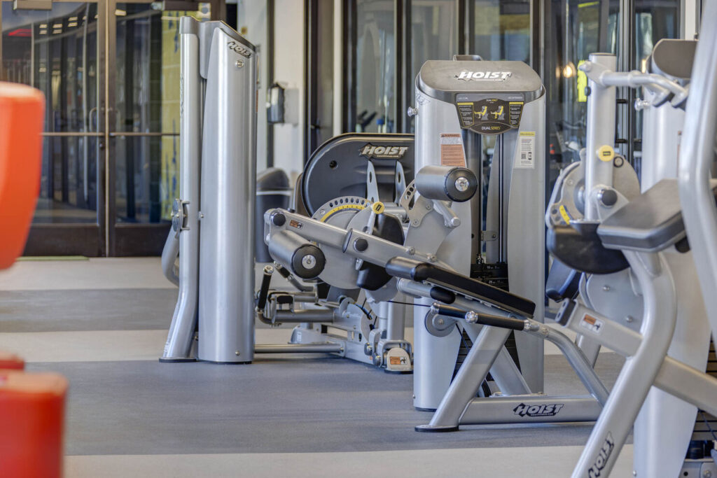The indoor gym at featuring a sit-down weight lifting bench for strength training exercises.
