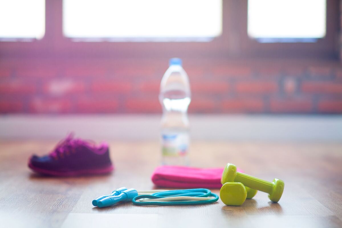 fitness equipment on the floor on workout area with a bottle of cold water