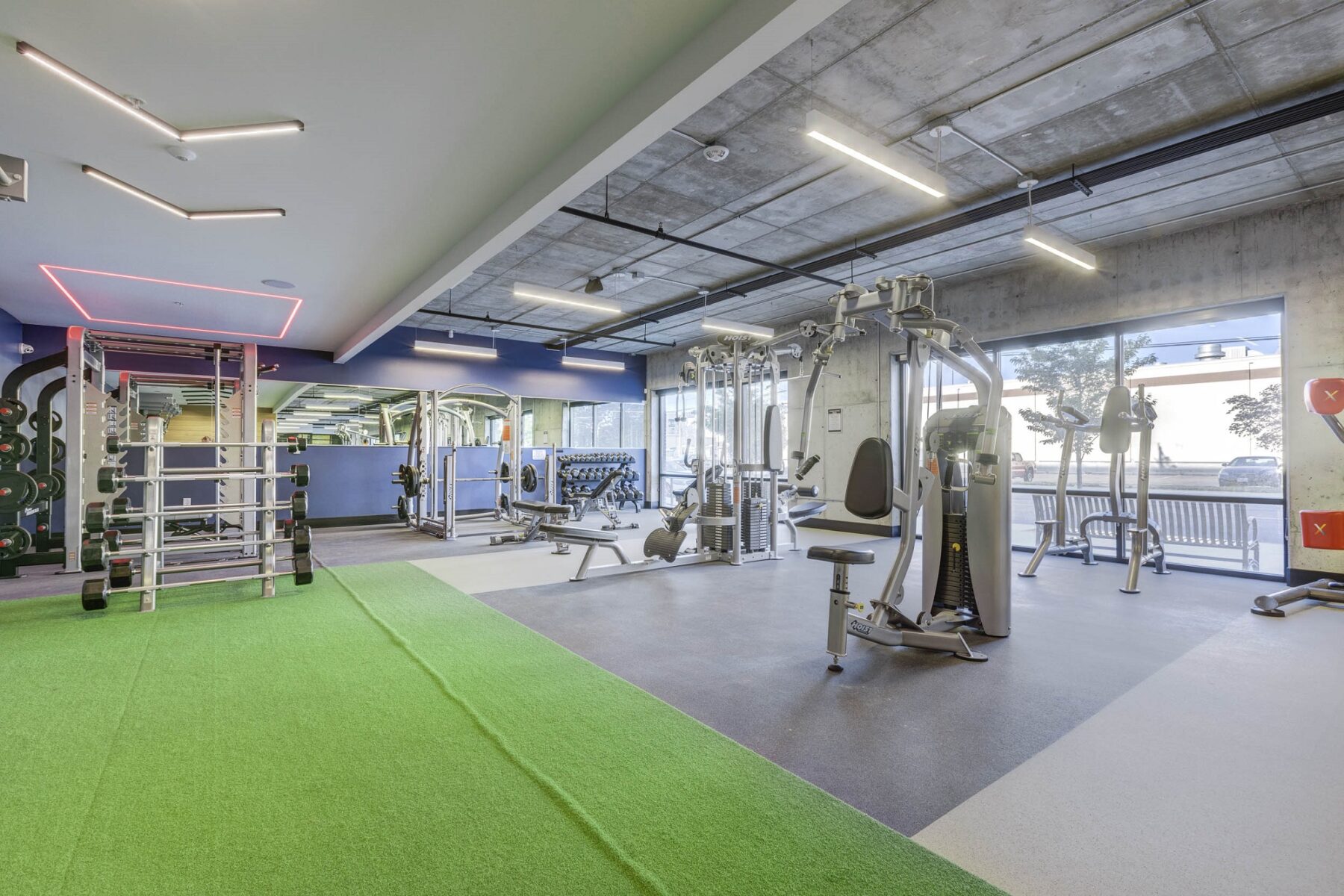 indoor gym with multiple exercise machines on a big open space